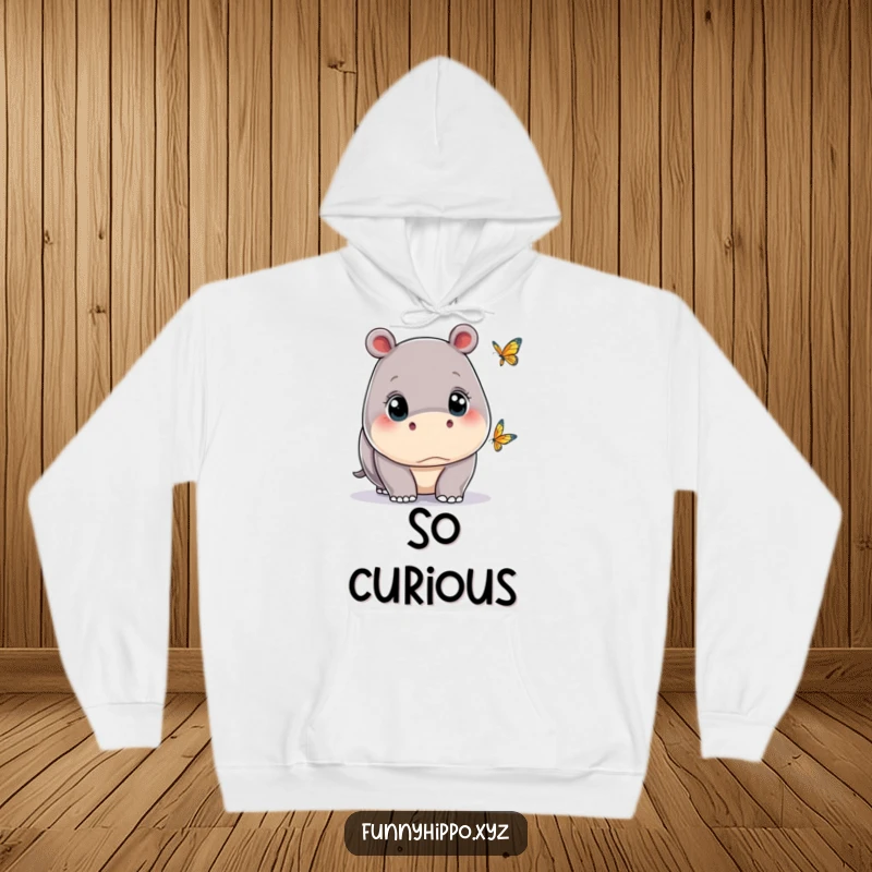 Funny kawaii hippo with wide eyes, captivated by a tiny butterfly, illustrated on a cozy and warm hoodie.